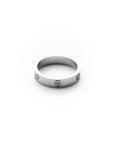 Silver ring with engraved symbols on a white background